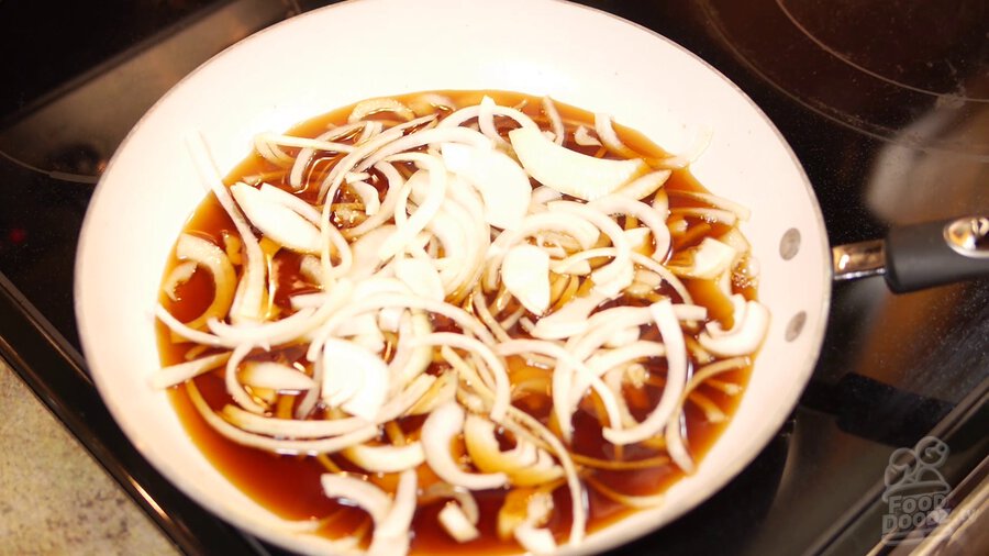 sliced onions are added to pan containing sauce mixture