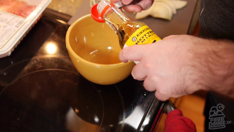 Mirin is poured into measuring cup before being added to bowl with dashi powder