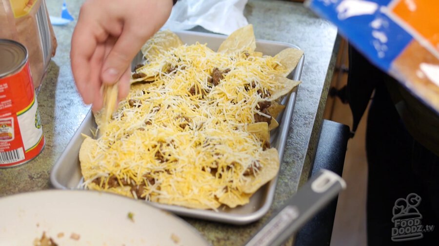 Grated cheese is added on top of ground beef