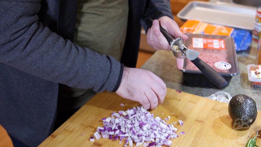 Garlic is minced with garlic press