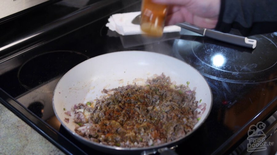 onion powder, garlic powder, cumin, oregano, paprika, cayenne, and salt to pan with ground beef, onion, and serrano