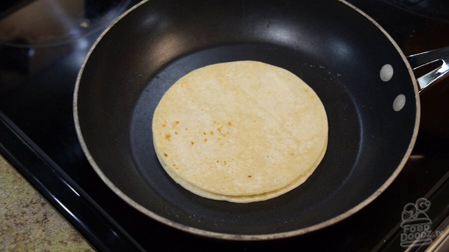 Corn tortillas are toasted in non-stick skillet