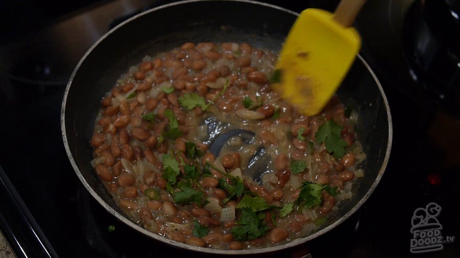 Skillet is removed from heat and cilantro and lime juice is stirred in with large spoon. Looks ready to eat!