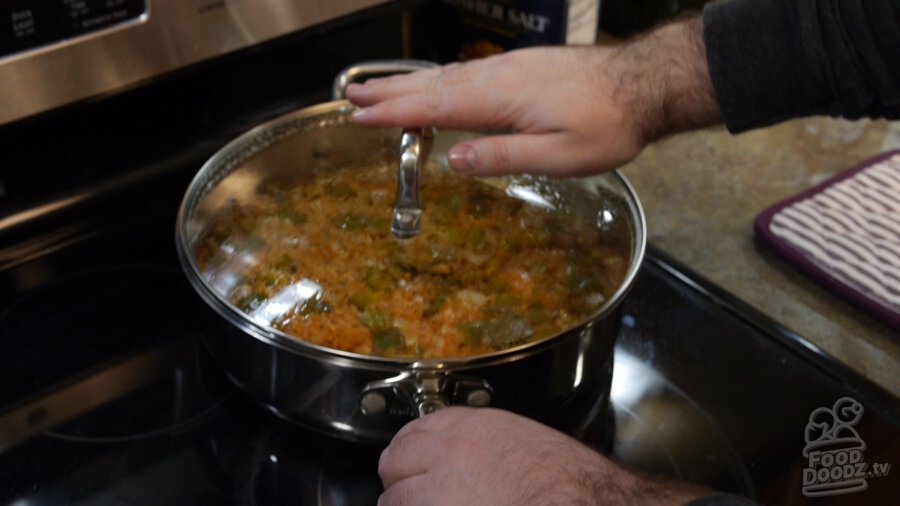 Hands slide pot off burner to cold part of stove to rest. The lid is left ON!