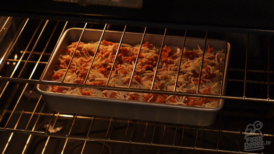 Unbaked pan pizza sits in middle rack of oven