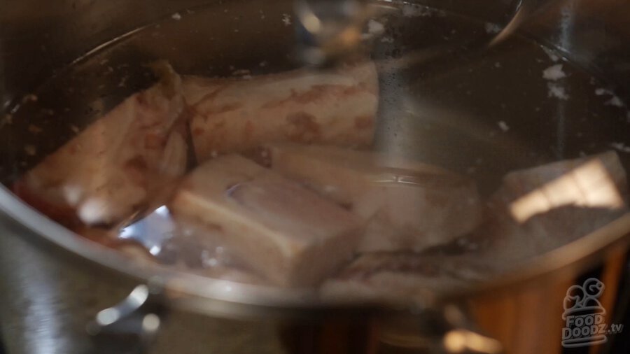 Instant Pot filled with beef bones and covered with water starting to boil