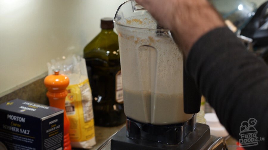 Removing lid from blender after boiled and rinsed cashews have been blended into puree in blender