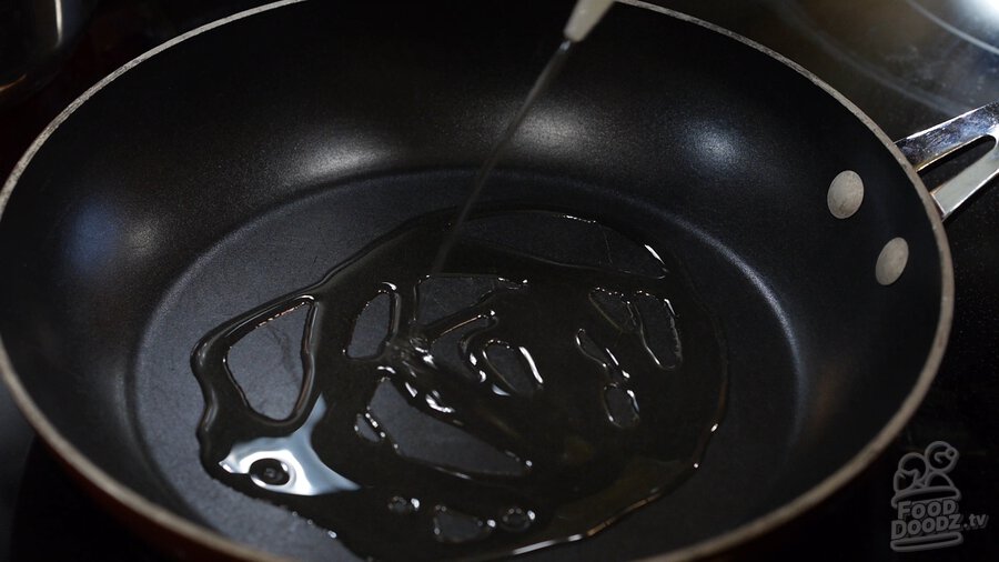 Adding vegetable oil to skillet