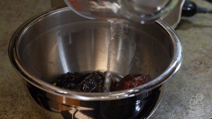 Pouring water over dried chilies after microwaving and placing in bowl (New Mexico Chiles, Ancho, Arbol)