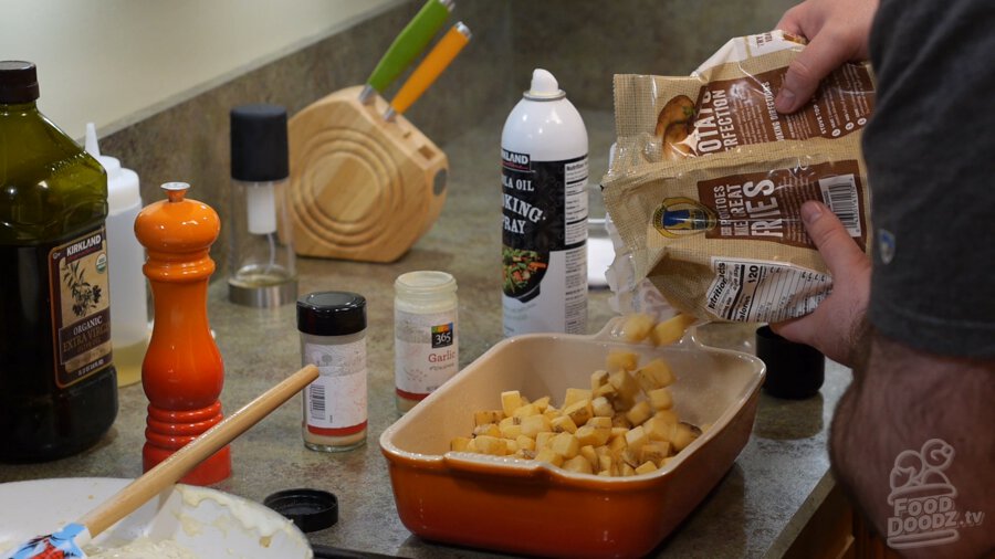 Frozen hashbrowns added to baking dish