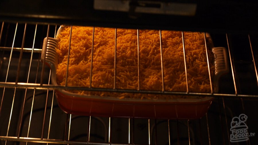 Hashbrown casserole being placed in the oven