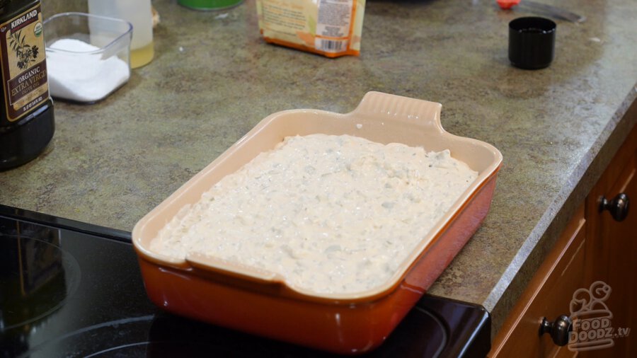 vegan cream of celery soup mixture spread evenly over frozen hashbrowns