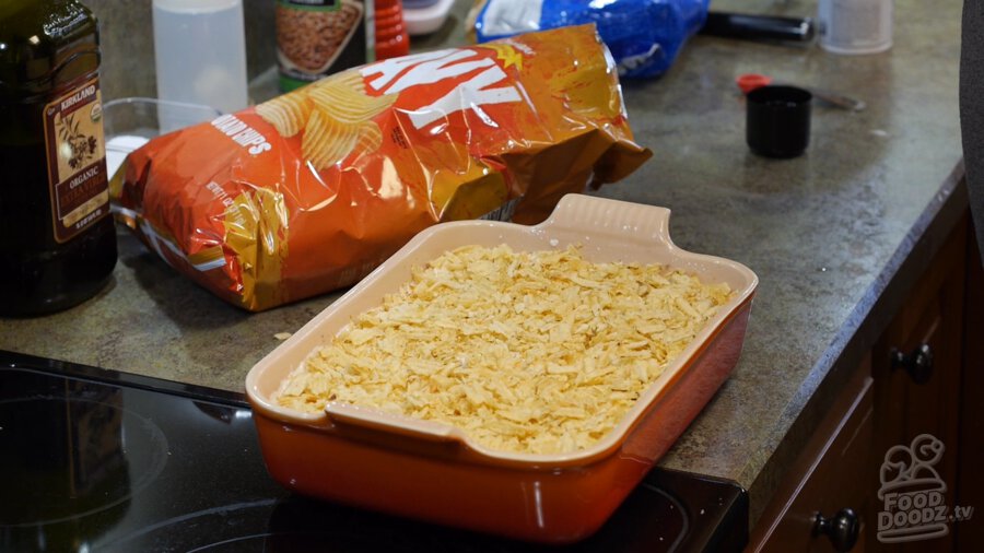 Crushed up chips spread evenly over the vegan cream of celery soup mixture 