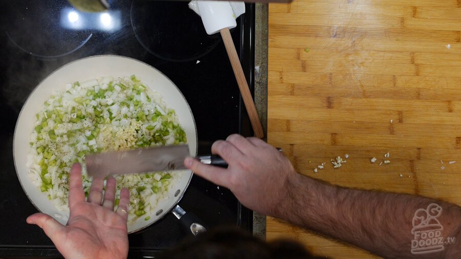 Minced garlic added to sauting onions and peppers