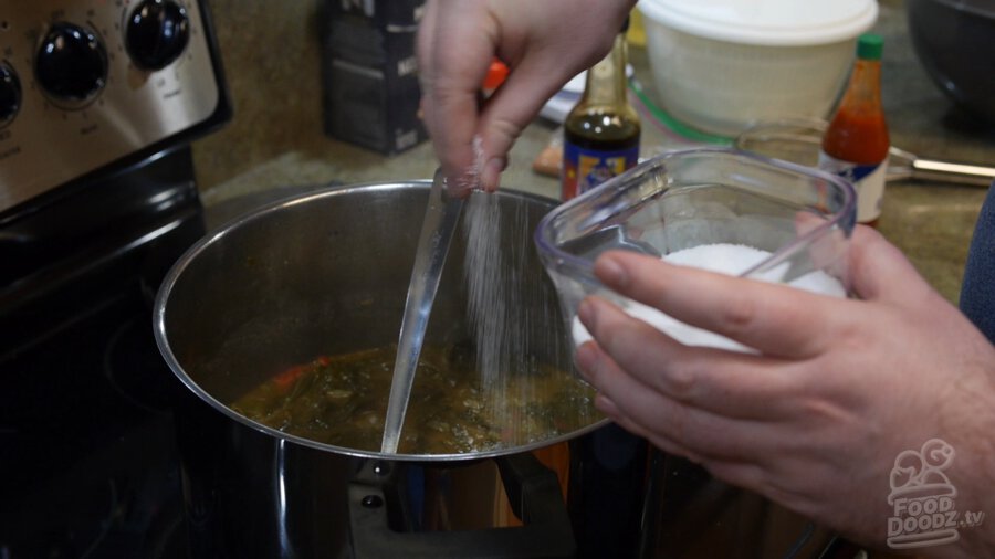 salt being added to finished gumbo