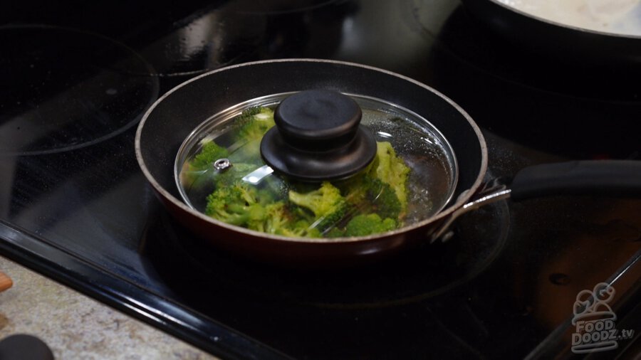 Lid and more water are added to stop garlic from browning more