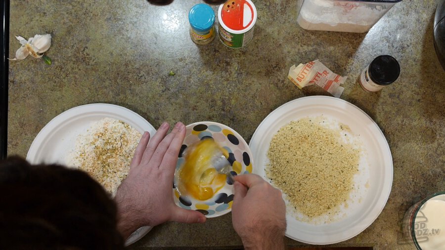 Egg and milk added to bowl and beaten