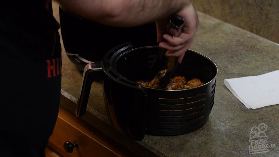 Flipping the wings over one last time before putting back in the air fryer for another 3-4 minutes at 400F