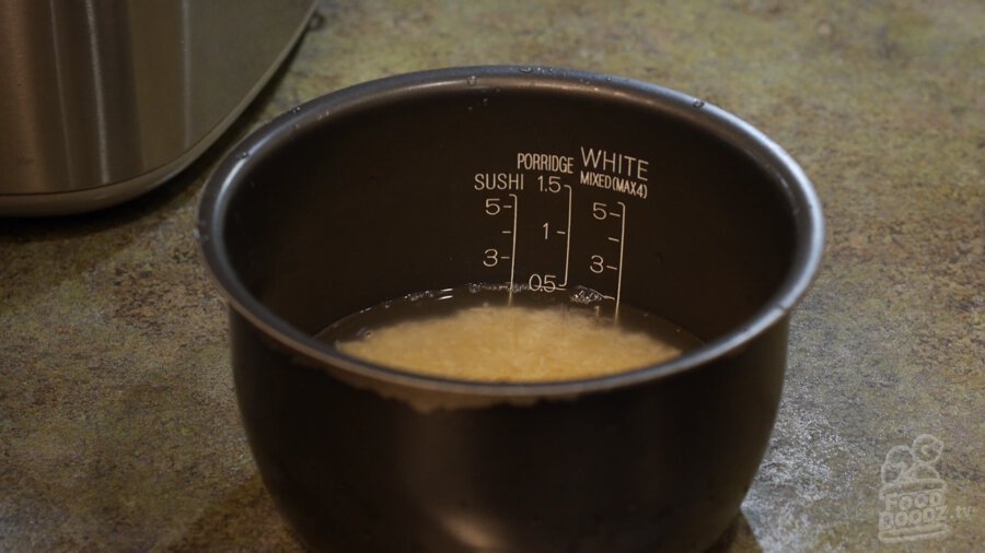 Washed rice in rice cooker bowl