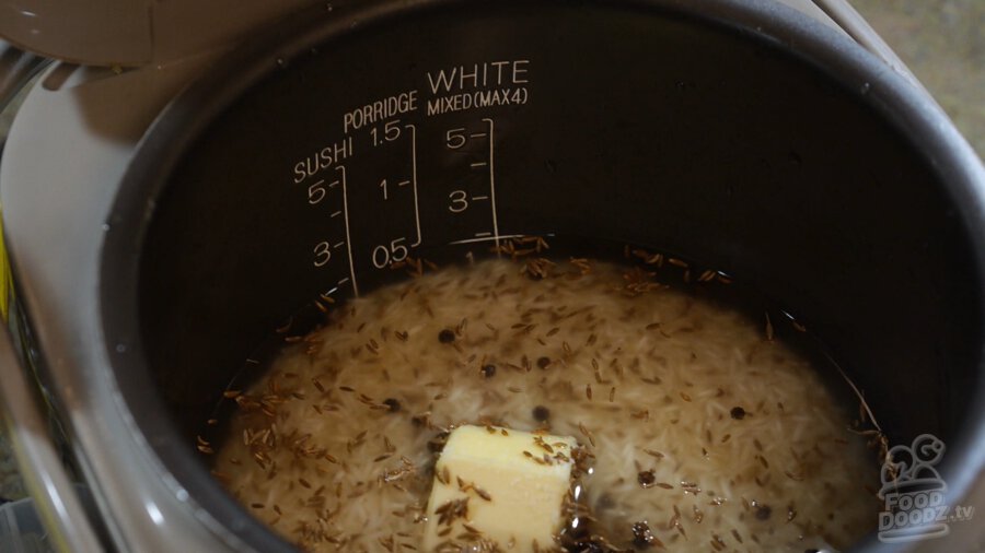 Rice with cumin seeds, water, butter, salt, and black peppercorns