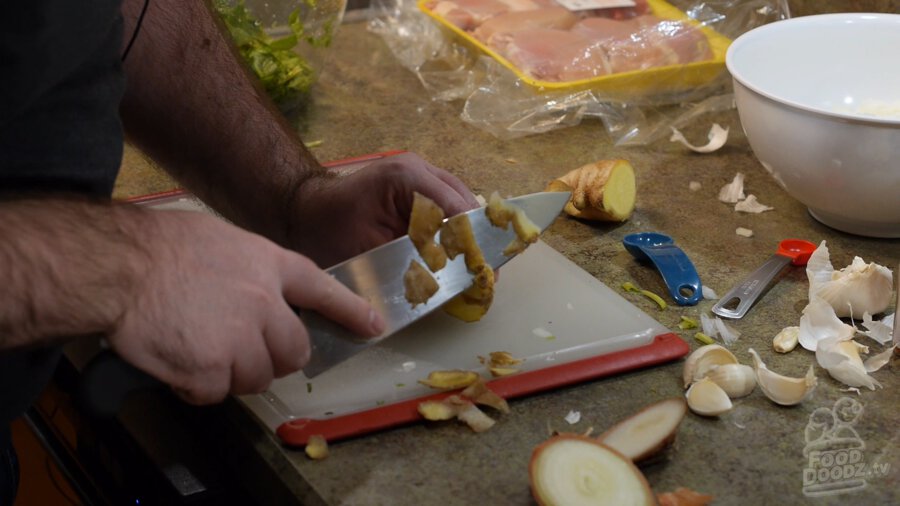 peeling ginger with a knife