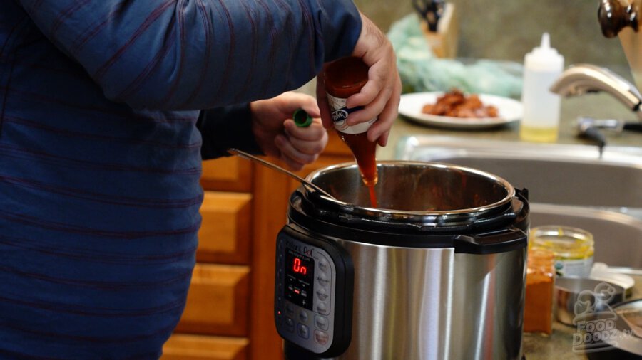 Hot sauce being added to pot