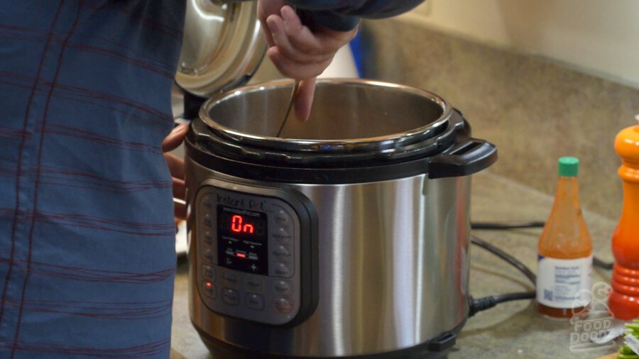 Mashing the beans up against the side of the pot while it's simmering