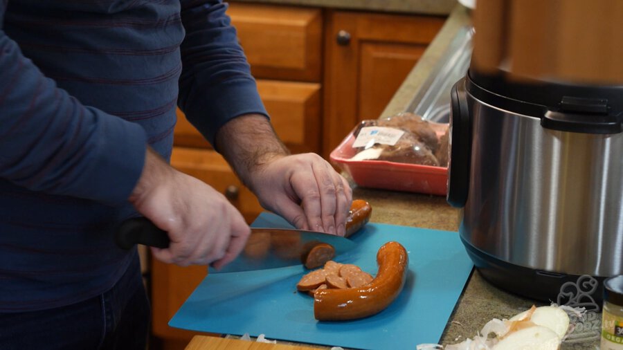 Slicing andouille into coin sized pieces