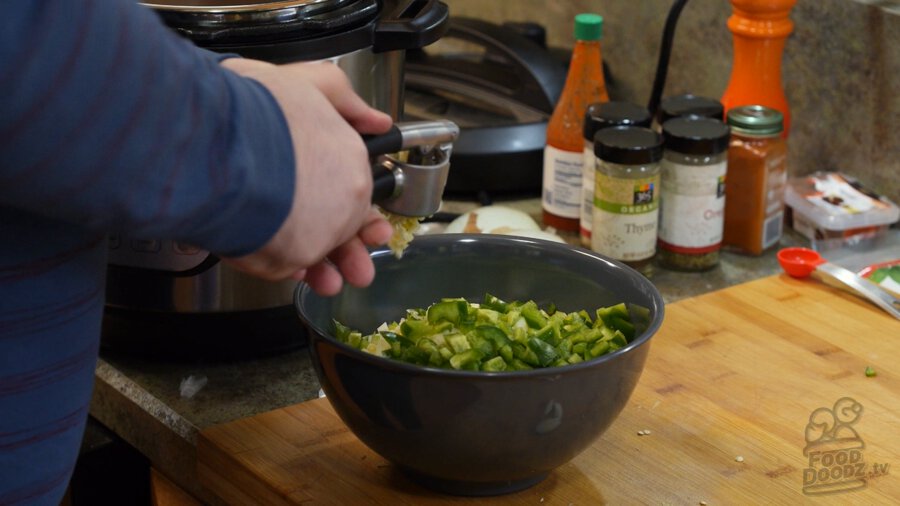 Putting garlic through a garlic press