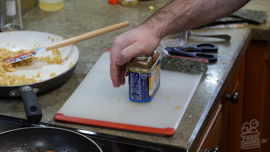 Packing down the rice with spice jars