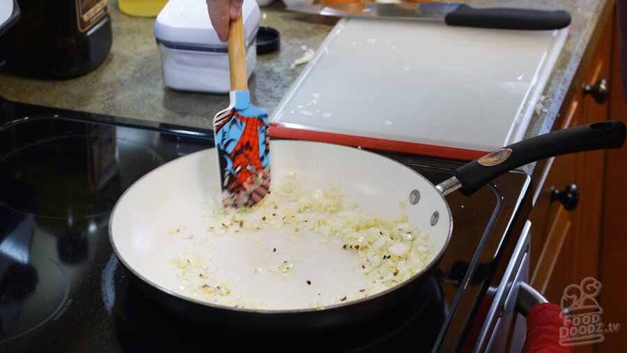 Garlic and chili flakes added to pan