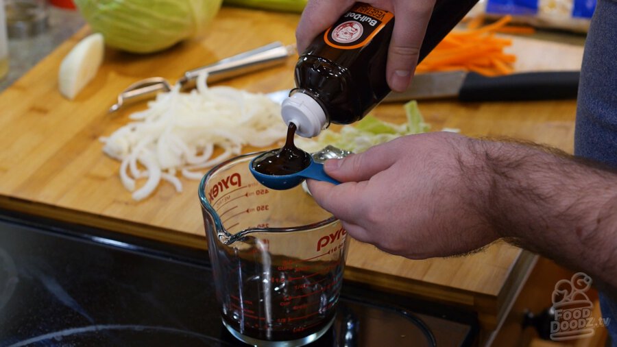 Adding vegetable and fruit sauce to bowl