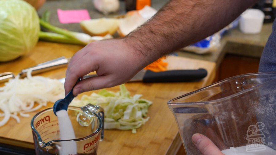 adding sugar to bowl