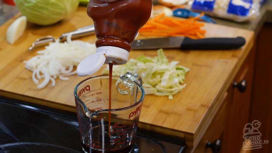 adding ketchup to bowl