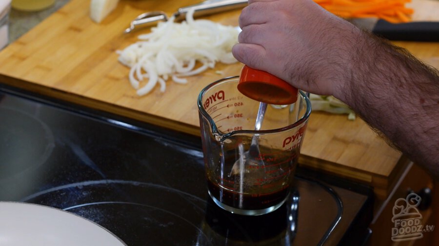 adding black pepper to bowl