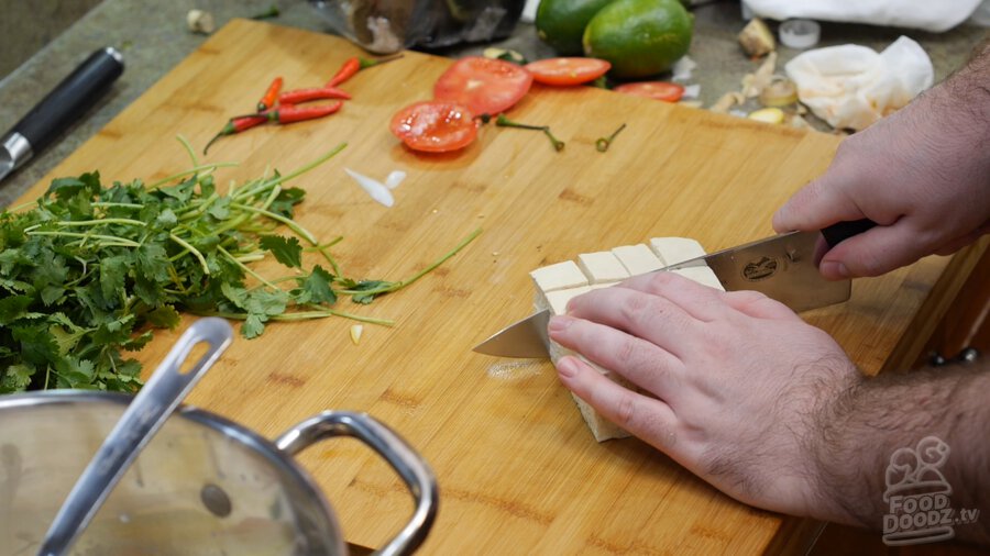 Cutting tofu up into cubes