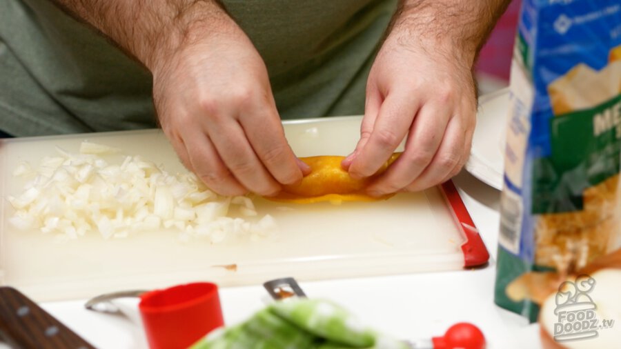 Finshing up the rolling of the tortilla to ensure a proper filling that doesn't leak out