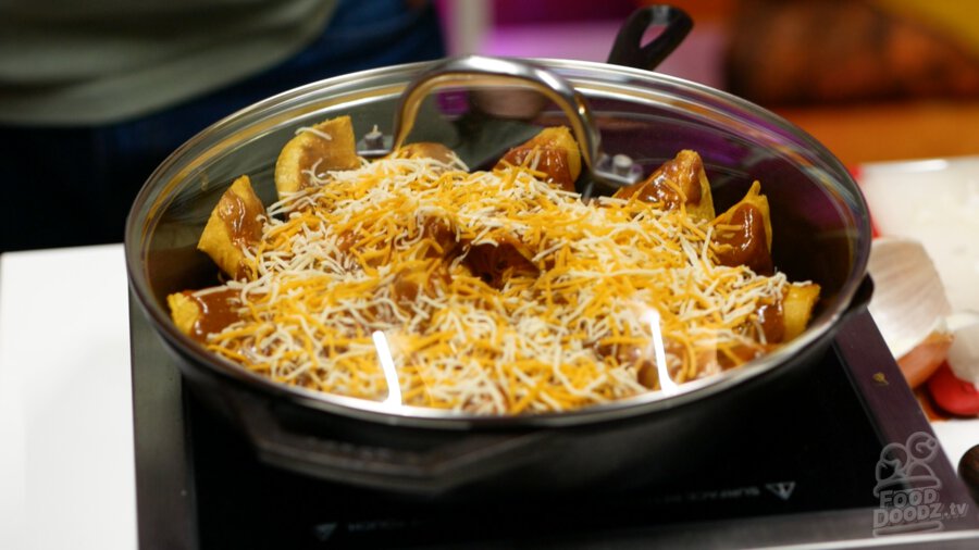 A lid placed on top of the enchiladas