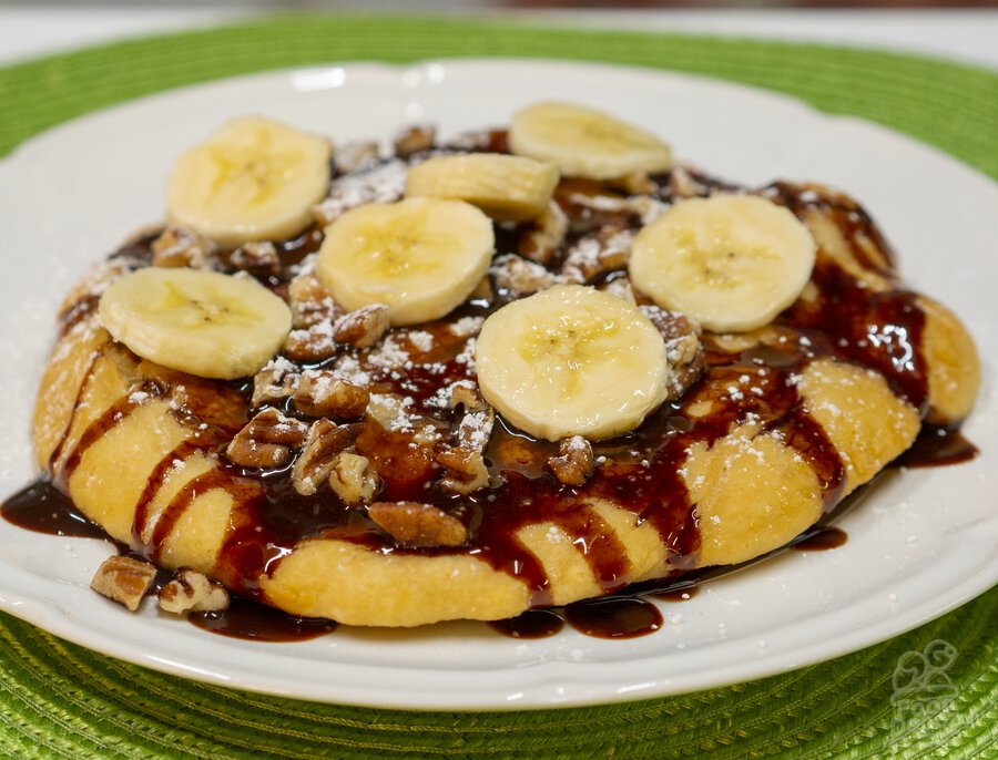 Indian (native american) fry bread topped with Hersey's chocolate sauce, crushed pecans, and powdered sugar!