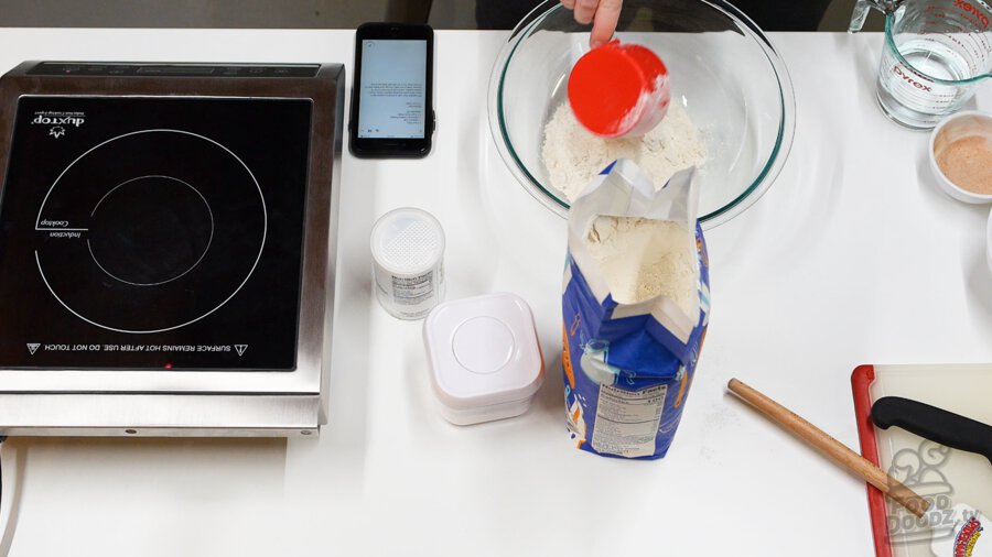 Adding flour to bowl