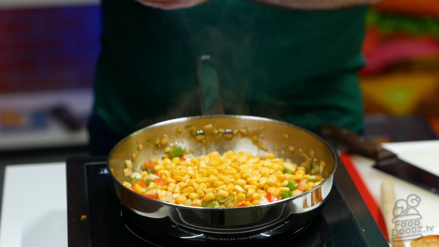 Adding frozen corn to pan