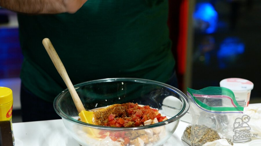 Cumin, chili powder, and oregano being added