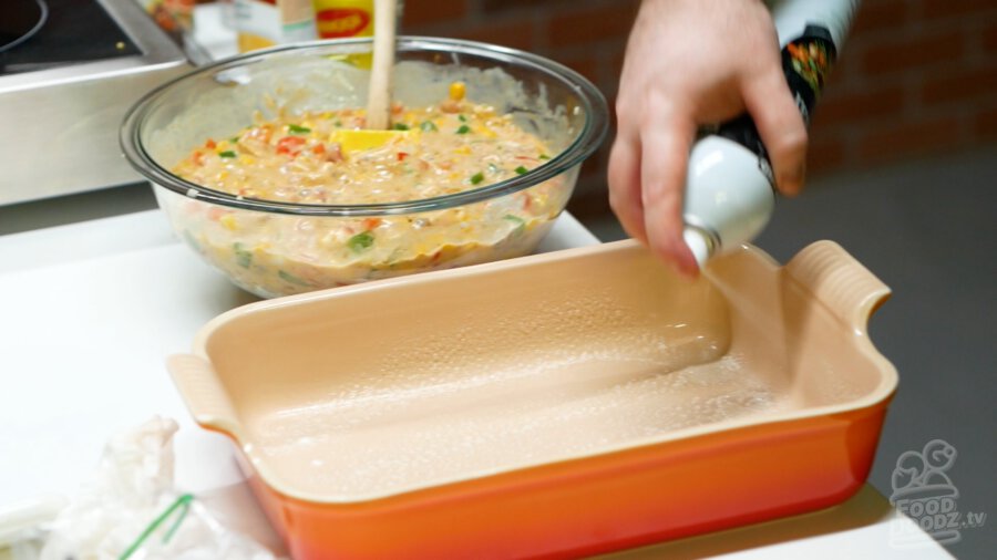 Spraying baking dish with cooking spray