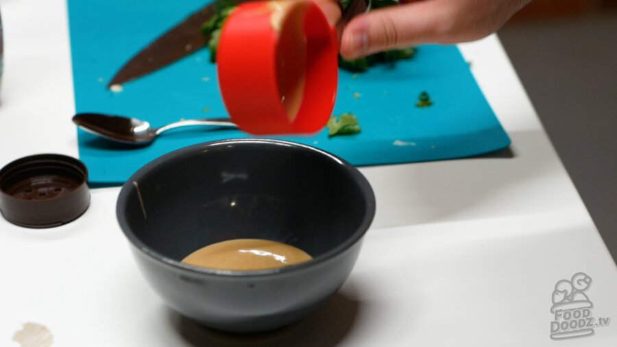 Adding tahini to bowl