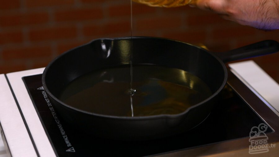 Adding vegetable oil to pan