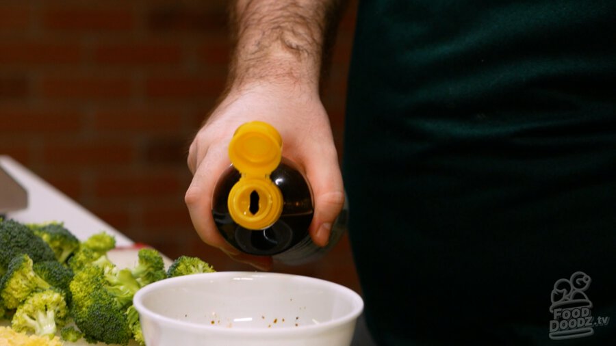 Adding sesame oil to bowl