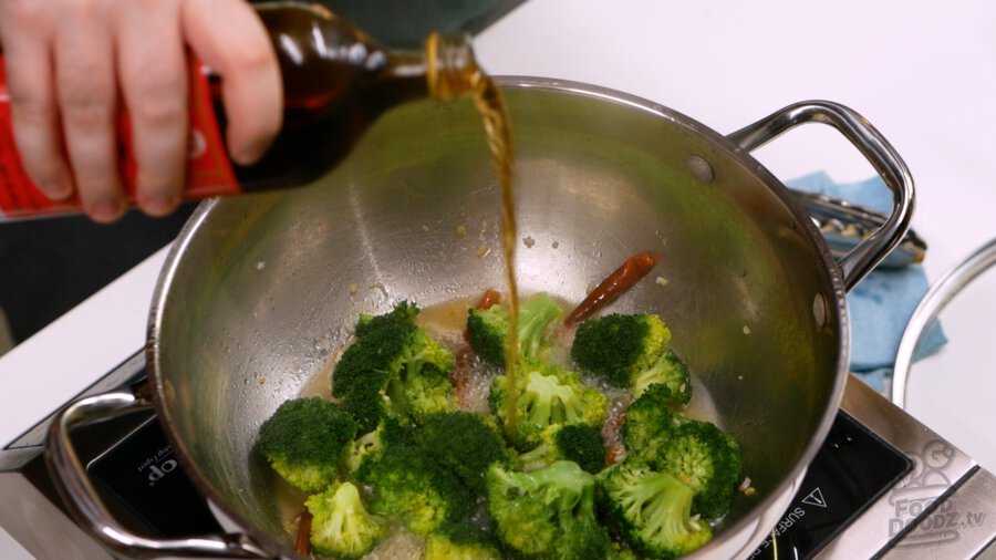 Shaoxing rice wine being poured over the broccoli