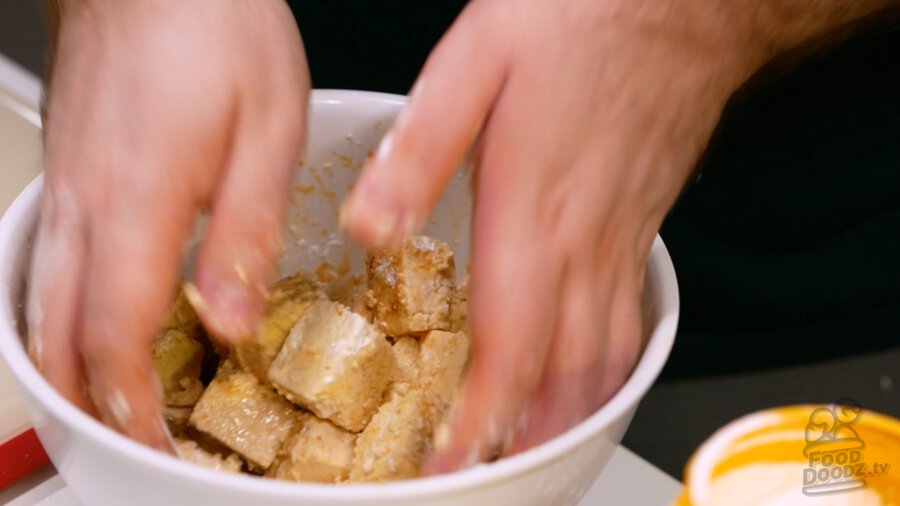 Carefully mixing tofu with hands