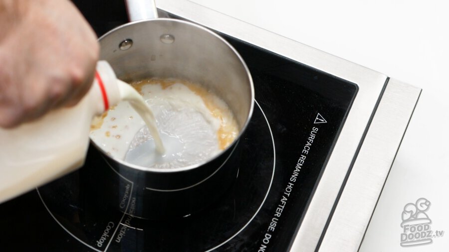 Adding milk to our roux