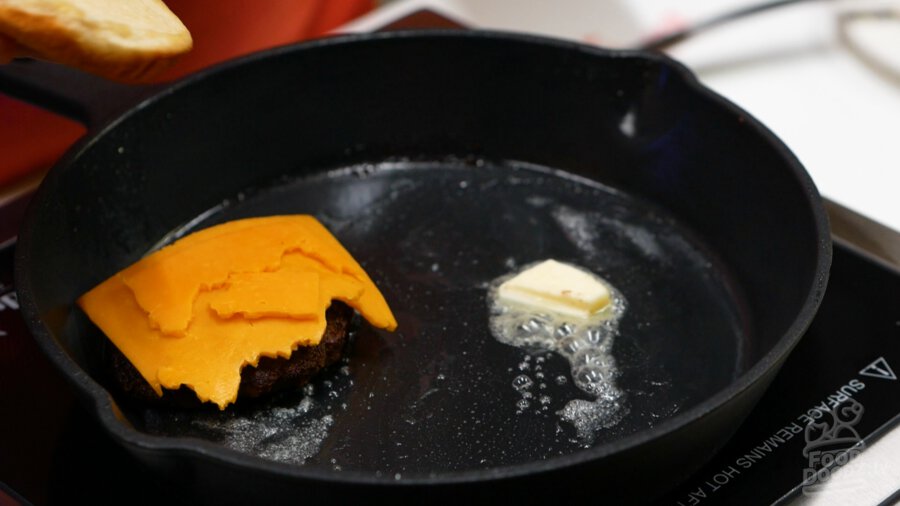 Adding cheddar cheese to the top of our cooked sausage patty